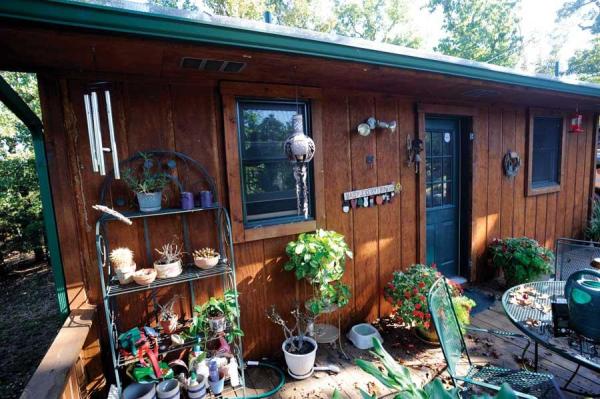 The deck in back is half the size of the house, and adds valuable space for relaxing and entertaining, as well as nurturing an assortment of potted plants.